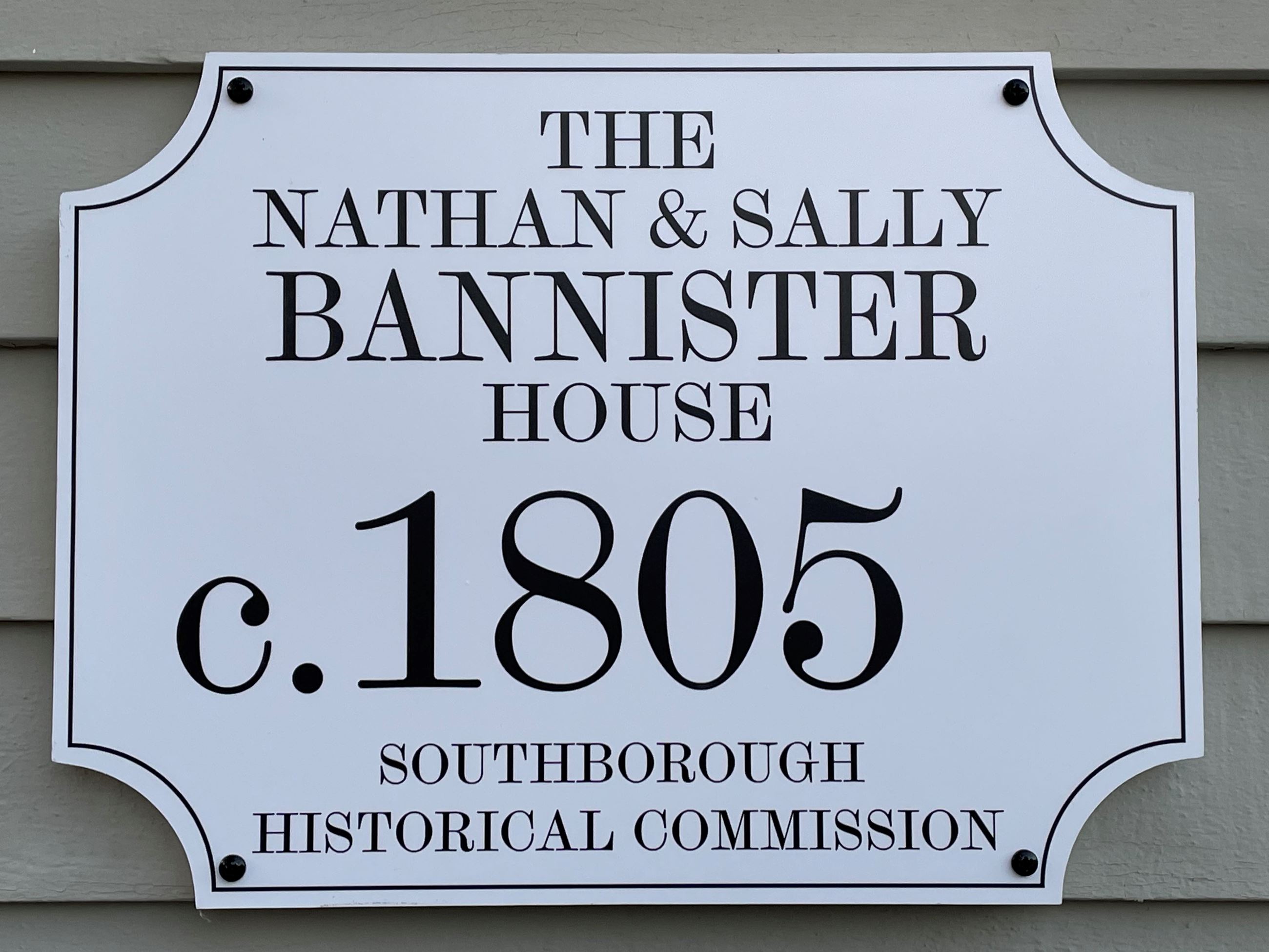 White Bannister House sign with black lettering